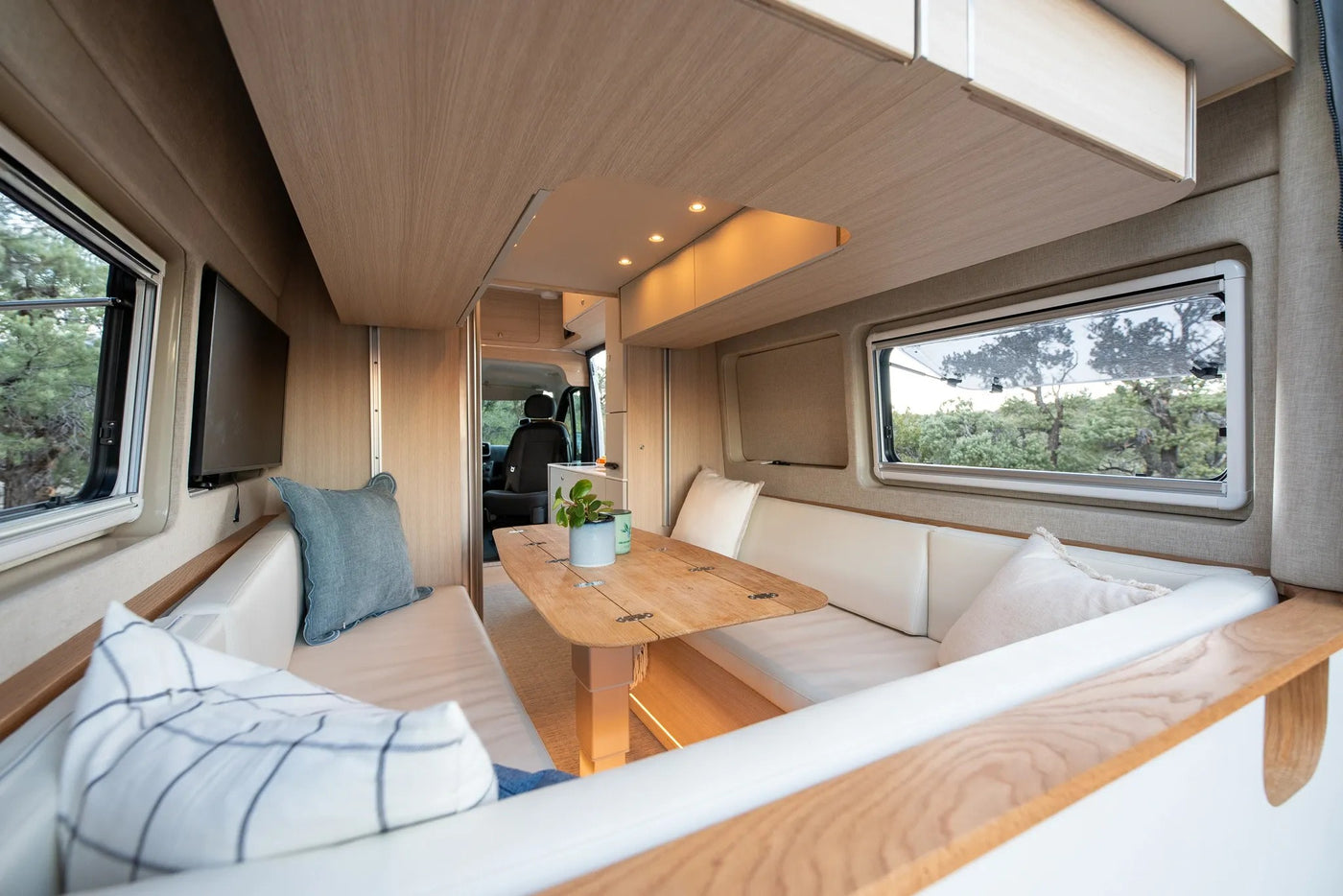  and panoramic outdoor views.|Cozy modern RV rental interior with dining area — photo 3
