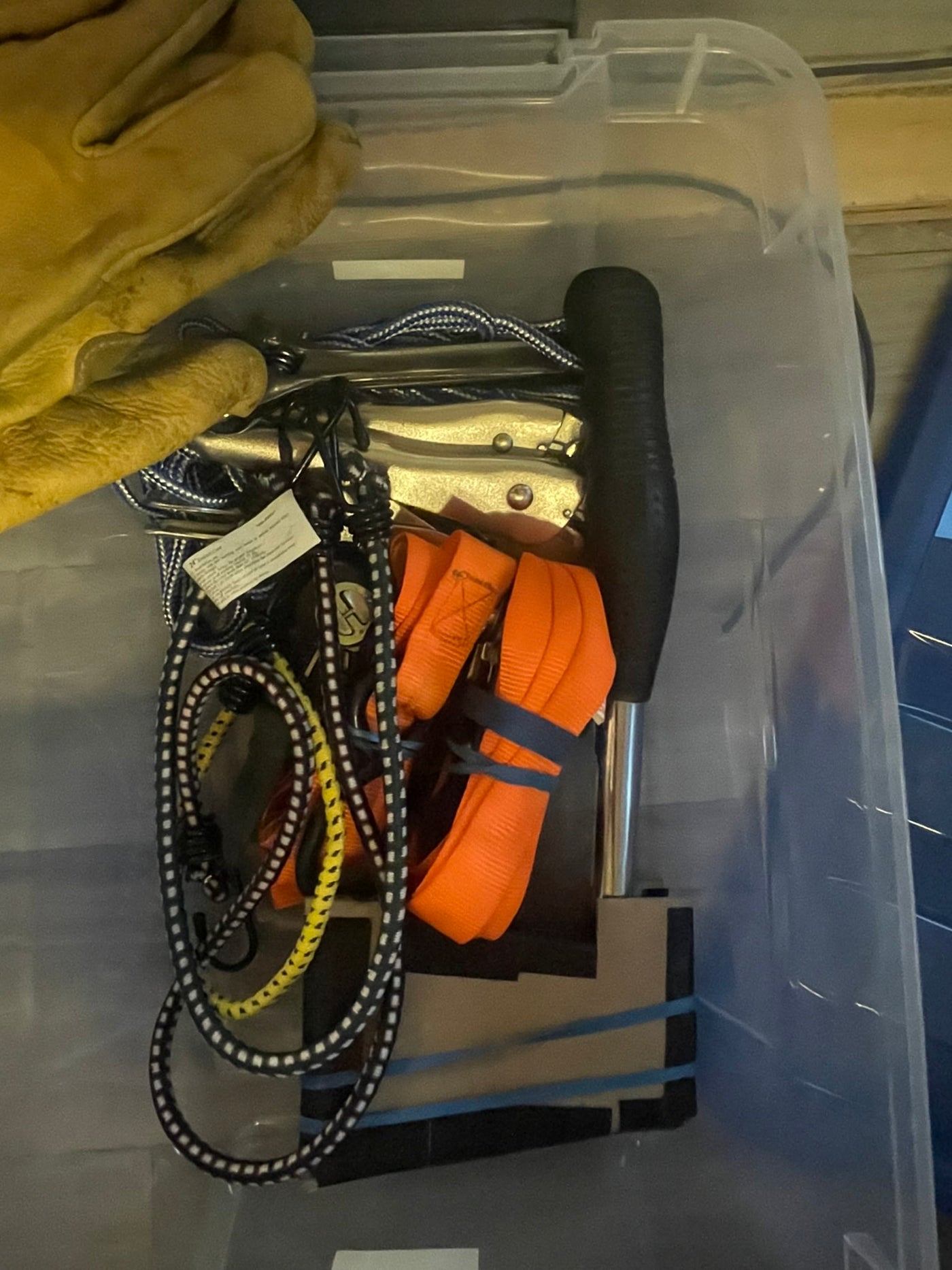 RV rental essential toolkit: A clear bin holds work gloves, bungee cords, tie-down straps, & knives/tools. — photo 16