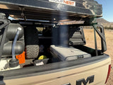 Overlanding truck bed: Roofnest tent, Dometic fridge, water tank, and spare tire. Perfect for your next rv rental adventure.