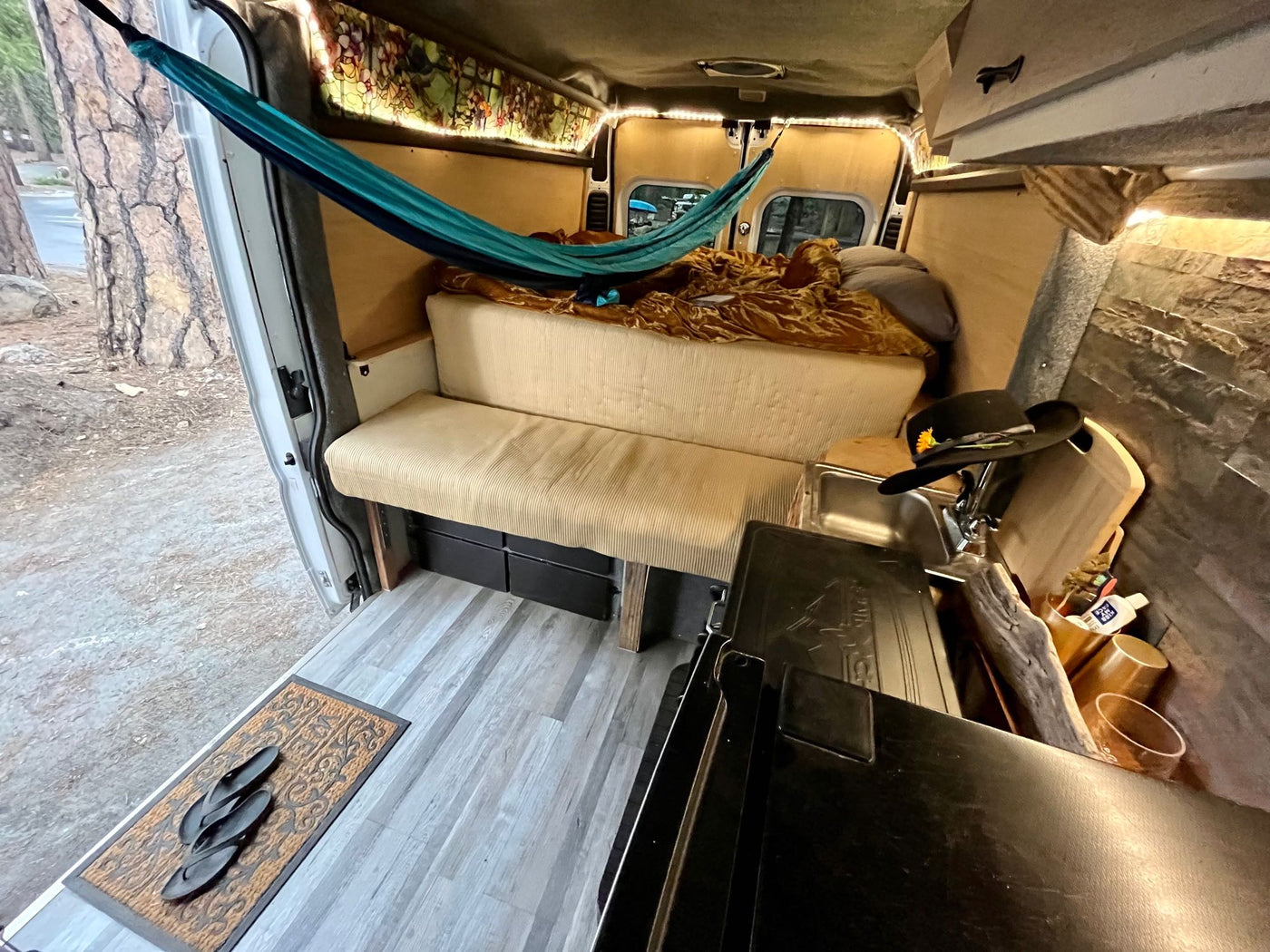  and rug.|Cozy RV rental interior showcasing a compact kitchen — photo 4