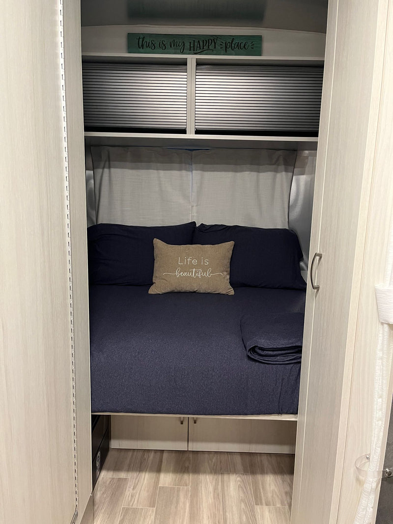  ready for an RV rental.|Inside an RV rental: a bright dinette area with blue seating — photo 8