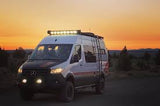 Adventure-ready RV rental! This off-road camper van with bright roof lights is perfect for exploring at sunset.