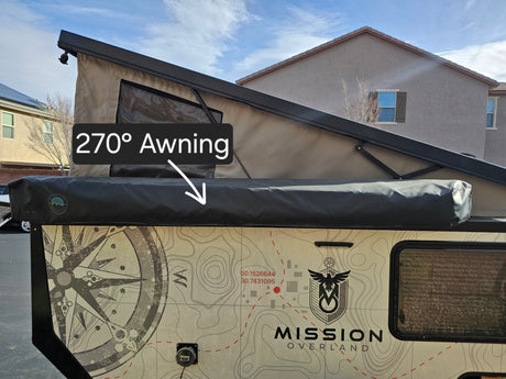 This Mission Overland camper trailer RV rental features a 270° awning and distinctive topographic map graphics on its side.