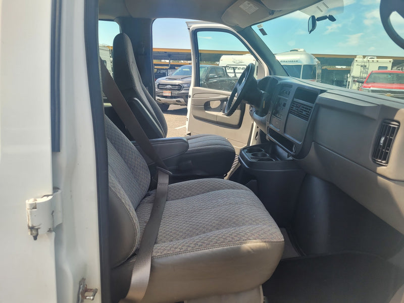  suggesting an RV rental pick-up.|Spacious van interior with open rear doors — photo 9