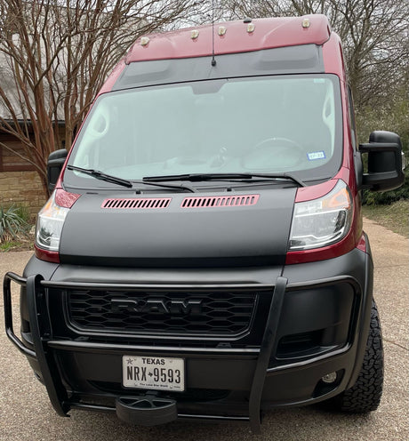 Front view of a rugged maroon and black Ram ProMaster van, perfect for your next RV rental adventure.