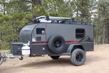This grey InTech Flyer off-road rv rental is an adventure trailer with solar & rugged tires for camping.
