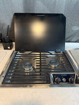 Dometic 2-burner RV cooktop in an rv rental, with its black glass lid open, ready for use.