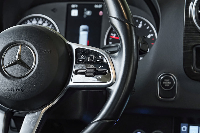 Driver's view of a Mercedes-Benz RV rental: detailed steering wheel with integrated controls, dashboard, and digital display. — photo 18