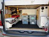 Explore with ease! Organized RV rental storage shows bins labeled for gear, cooler, and a water heater setup.