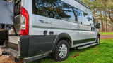 Silver Swift camper van, parked in a forest clearing, ready for your RV rental outdoor adventure.