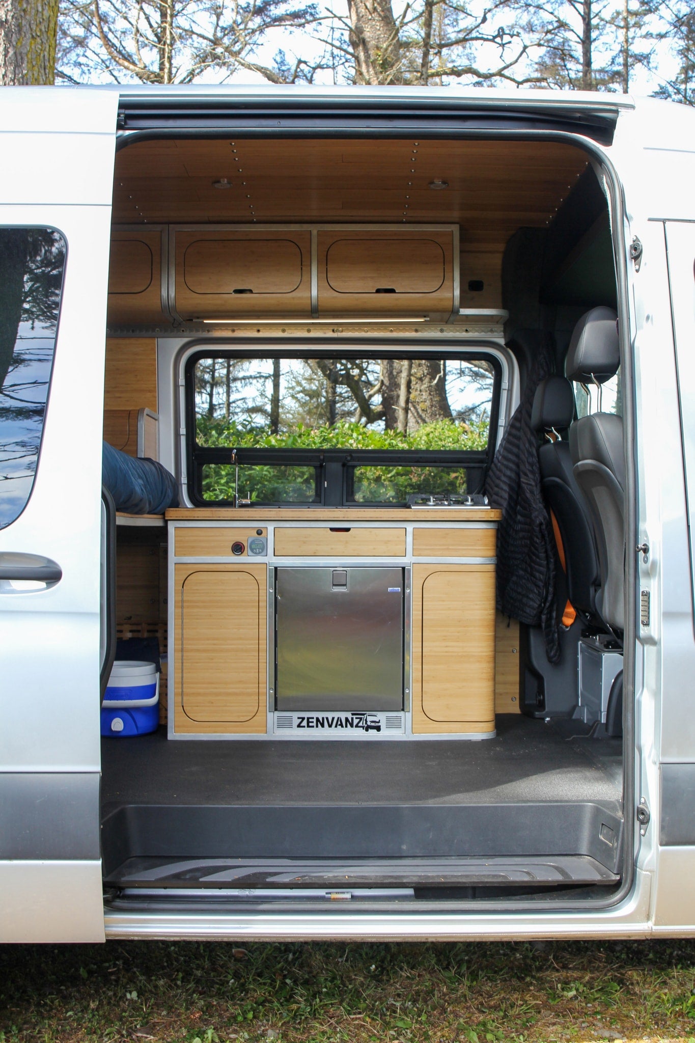 View inside a modern camper van RV rental, showing kitchen, sink, fridge, and bamboo interior. — photo 5