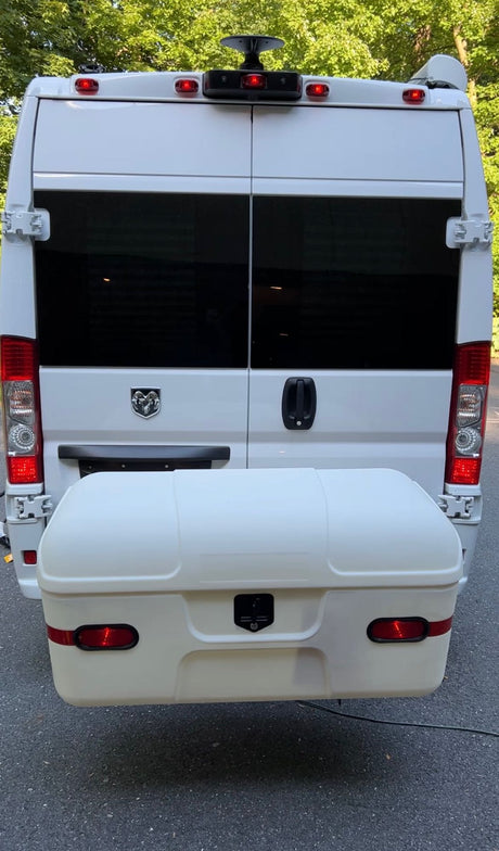 White Ram ProMaster rv rental van, showcasing its rear exterior with tinted windows and a spacious cargo box.
