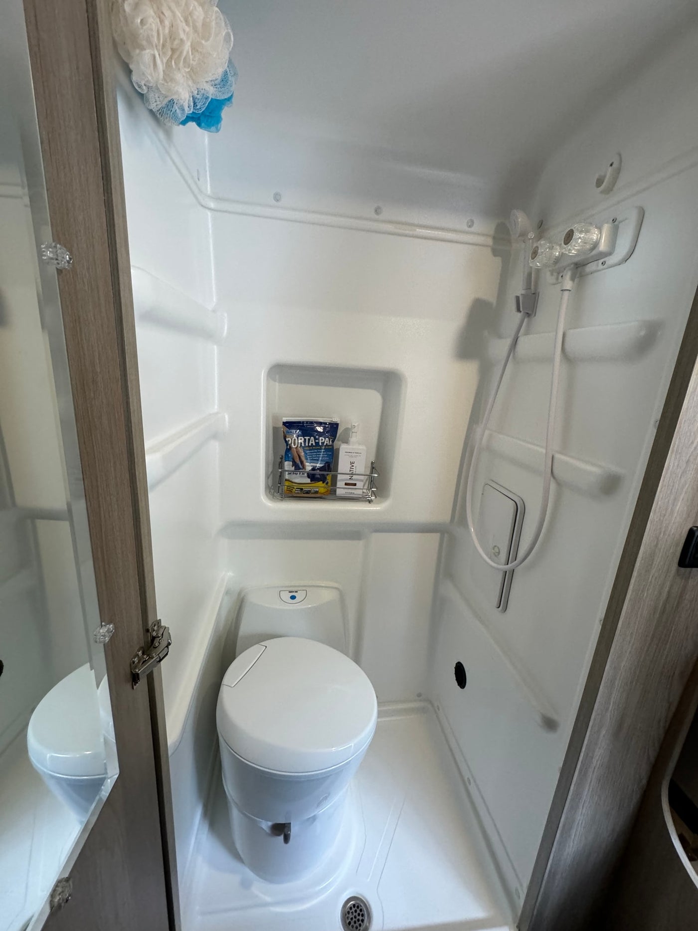  viewed from the open rear door.|Open rear of an RV rental showing a cozy bed — photo 14