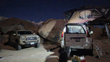 Night overlanding camp: a Toyota Tacoma & Lexus GX, both with rooftop tents, offer an RV rental-like wilderness stay.