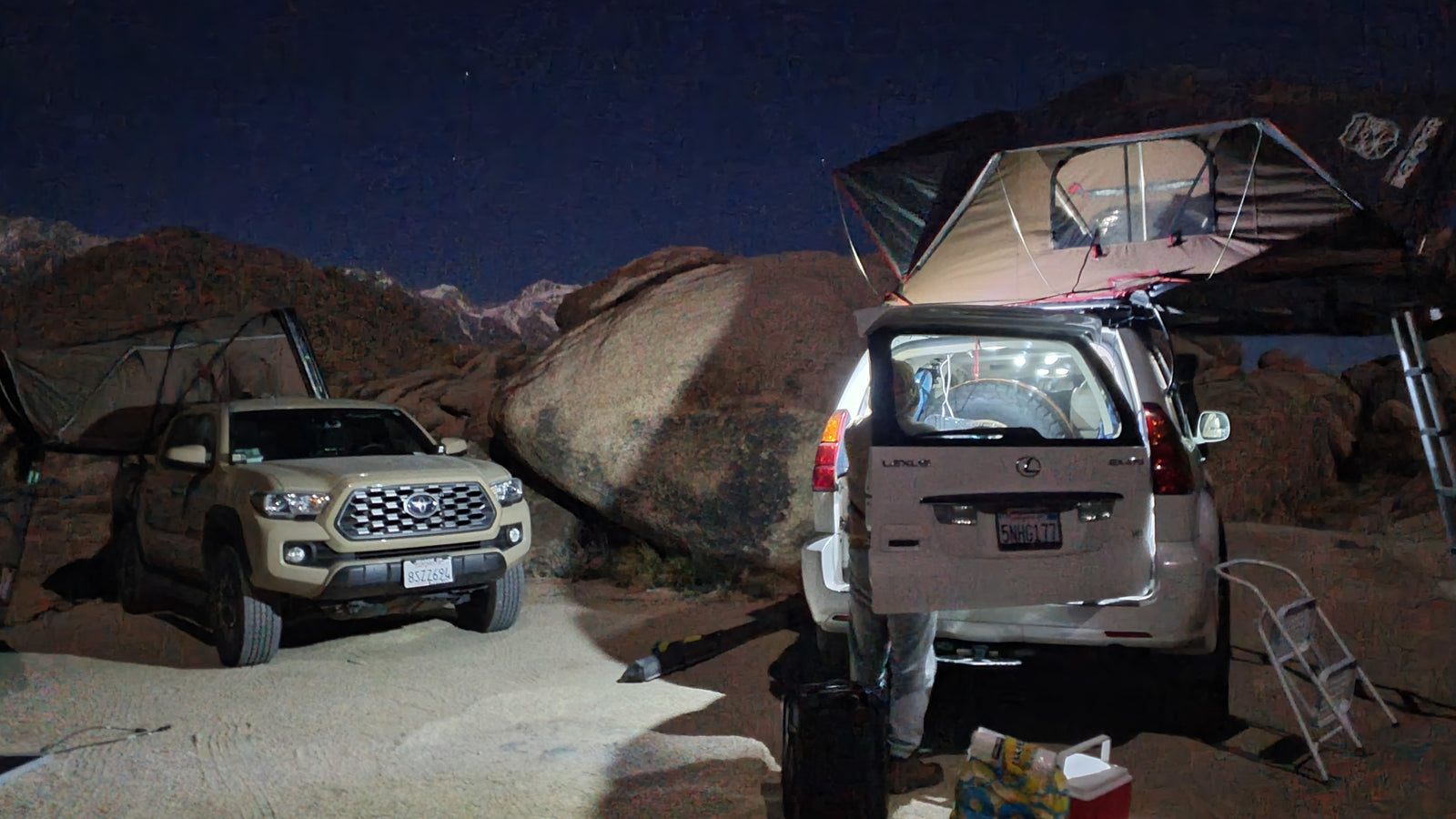 Night overlanding camp: a Toyota Tacoma & Lexus GX, both with rooftop tents, offer an RV rental-like wilderness stay.