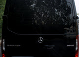 Black Mercedes-Benz Sprinter 3500 van, great for **rv rental**, rear view with reflections of trees and an RV.