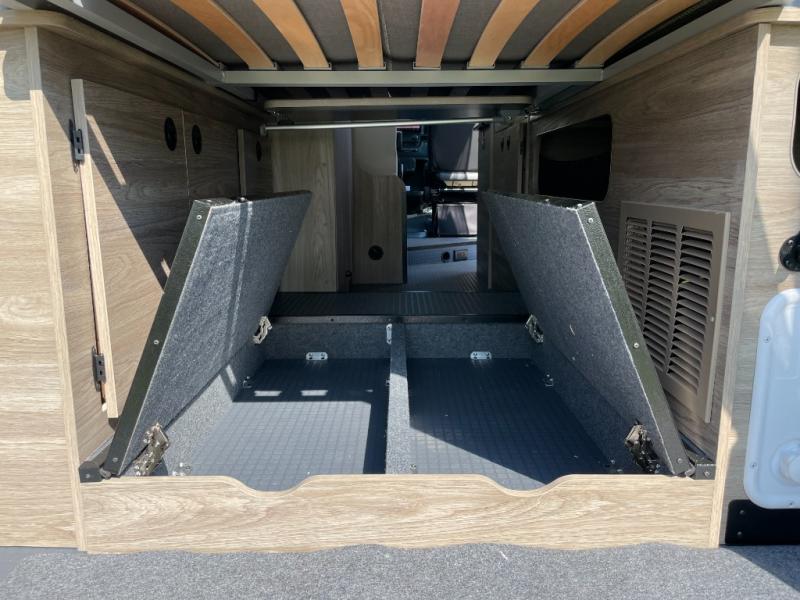 This **RV rental**'s rear storage features two hinged compartments open under the bed, ideal for gear.