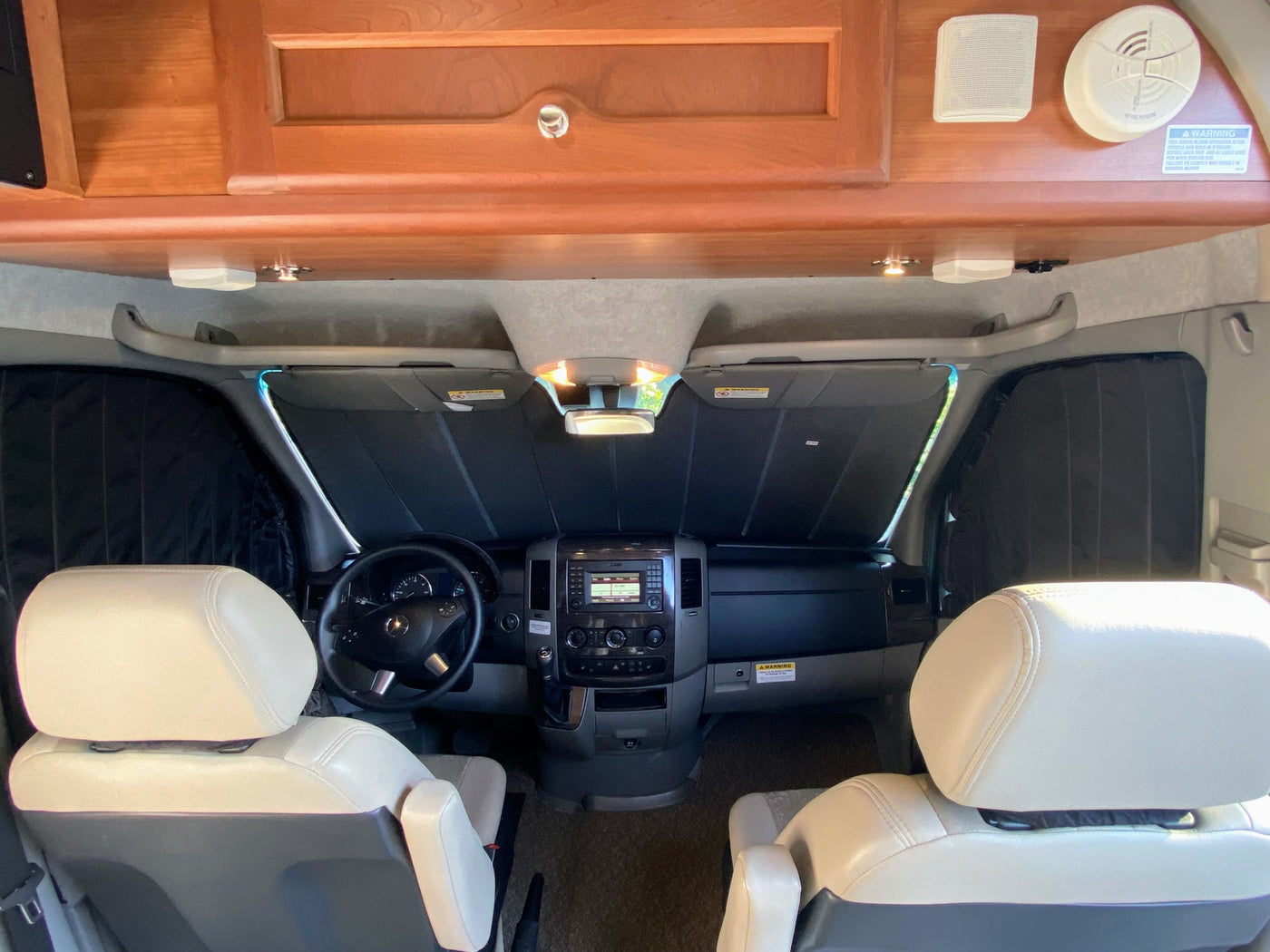  and|RV rental interior: cockpit with steering|View of an RV rental's cab: cream swivel seats|Compact and efficient wet bath in an RV rental — photo 7