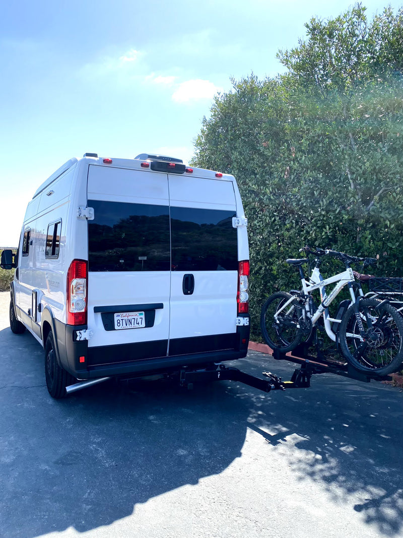 Rear view of a white RV rental van with a bike rack holding two mountain bikes, set for a road trip adventure. — photo 18