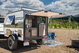 Compact Surray Sport rv rental with an outdoor kitchen setup, perfect for camping adventures in scenic nature.