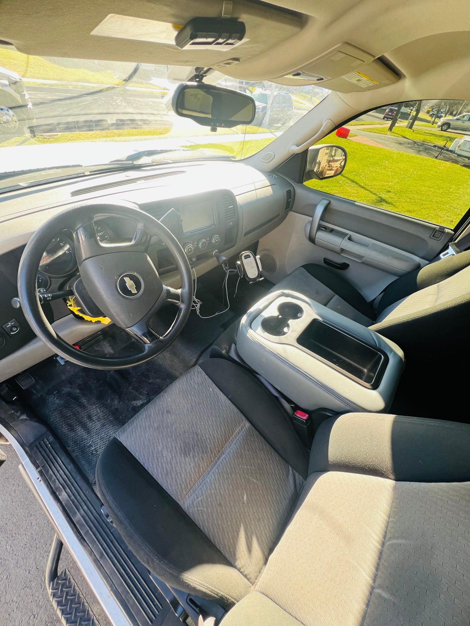 parked on an asphalt driveway.|Cozy truck camper interior with a bed
