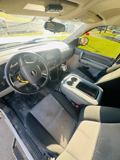 parked on an asphalt driveway.|Cozy truck camper interior with a bed