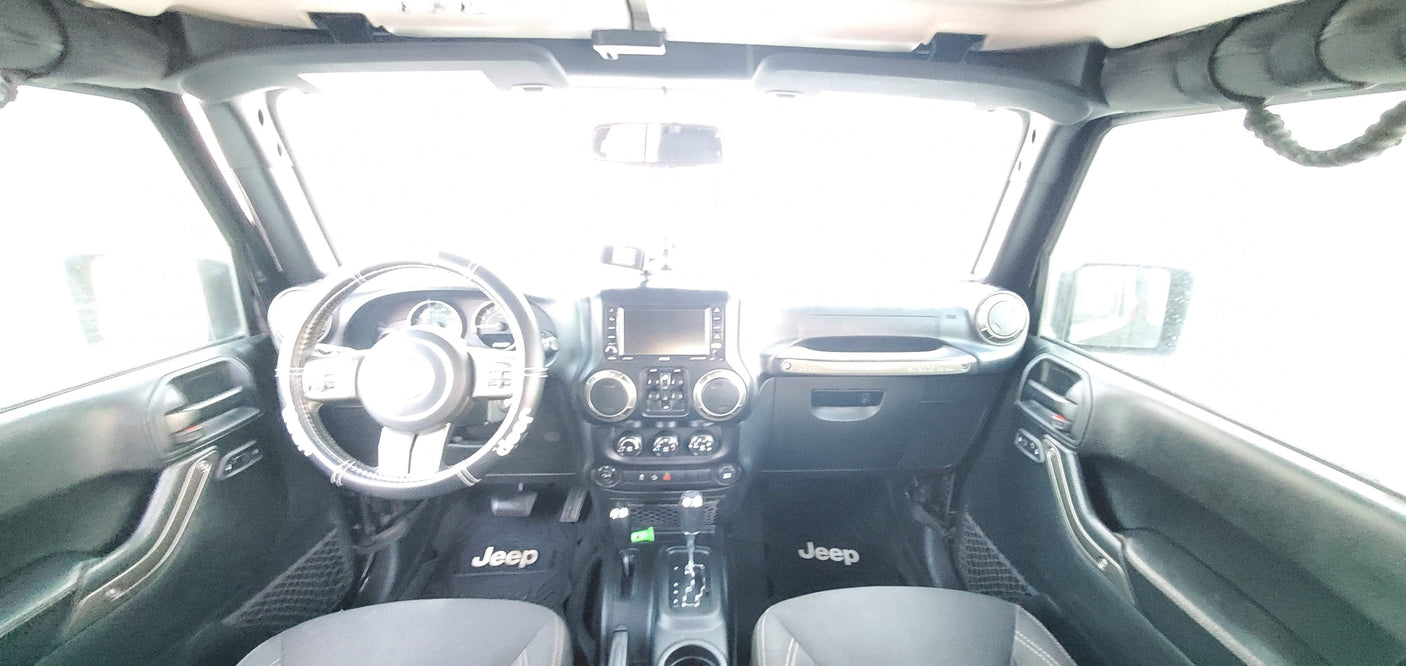 Interior of a modern vehicle showing the dashboard and steering wheel, perfect for an RV rental adventure.