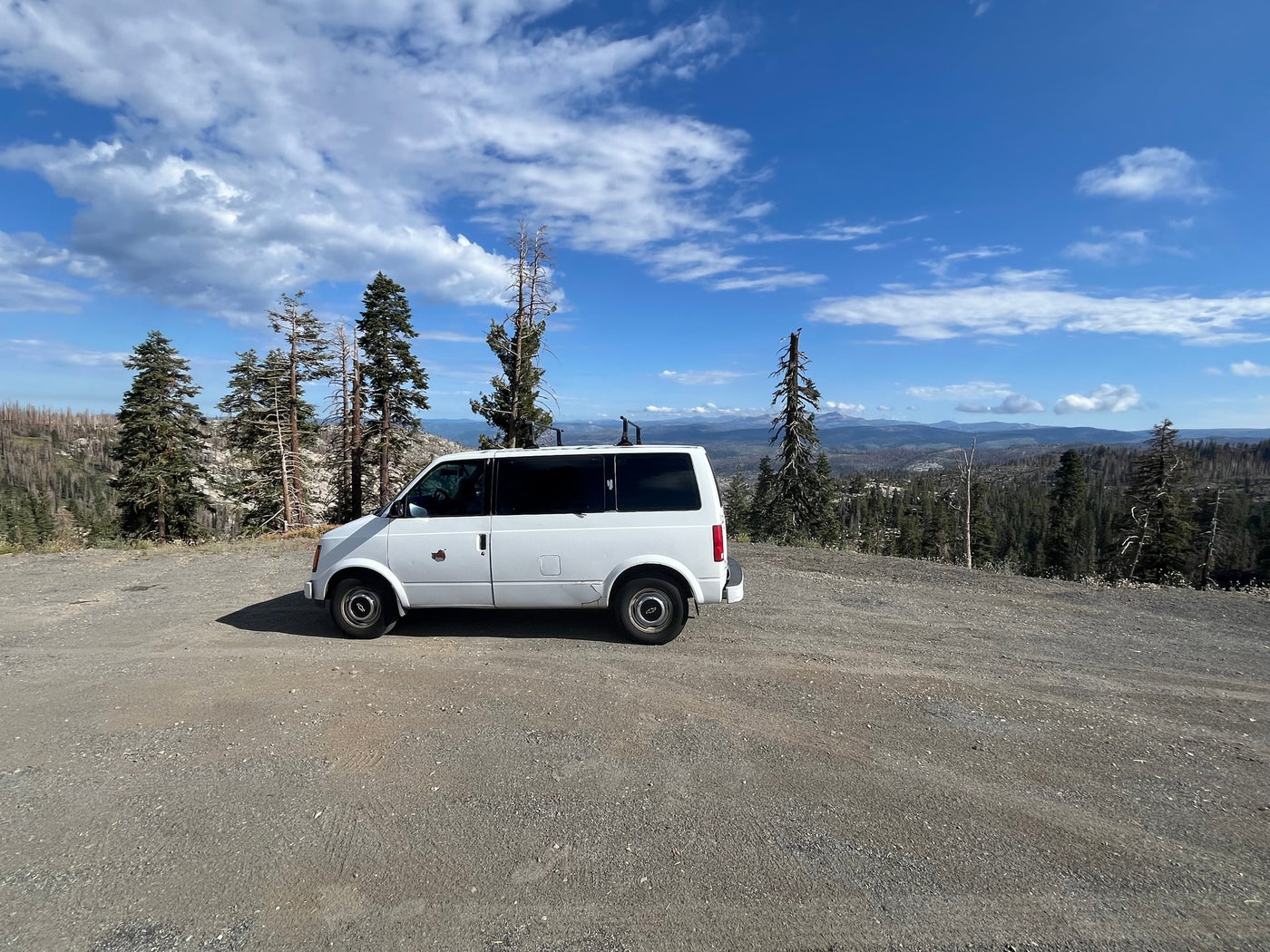  showcasing a vast forested mountain landscape under a bright blue — photo 2