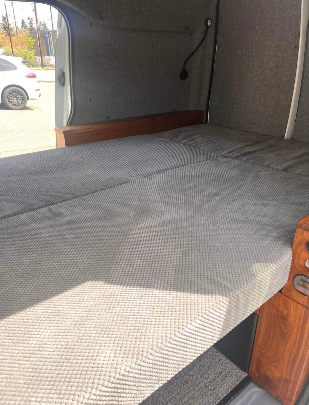  featuring wood cabinets.|Inside an rv rental: a grey bed — photo 4