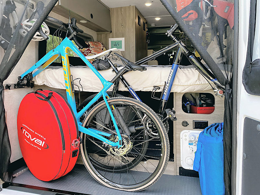 Inside this RV rental, two bicycles and cycling gear are neatly stored, showcasing smart space for adventure travel. — photo 9
