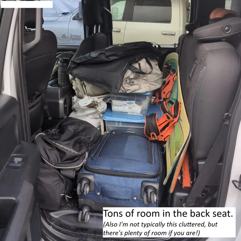 RV rental storage solution: Back seat packed with luggage, containers, & a snowboard, proving spacious for all your travel gear. — photo 17