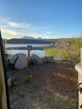 Scenic view from an RV rental at Gunlock State Park entrance, overlooking the lake and mountains.