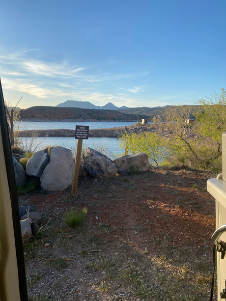 Scenic view from an RV rental at Gunlock State Park entrance, overlooking the lake and mountains.