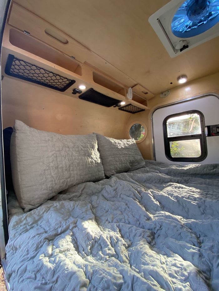  ready for outdoor adventures.|This RV rental setup features a teardrop camper with a large rooftop tent & ladder