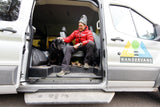 This RV rental shows a man and his dog relaxing in a WANDERVANS camper van, ideal for pet-friendly travel.