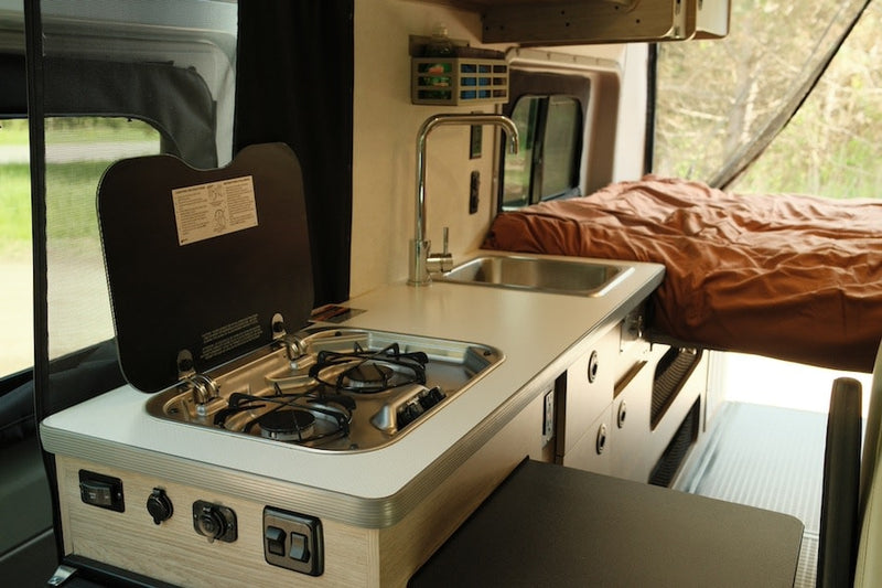  and rear mesh screen opening to nature. Ideal for adventures.|Cozy RV rental bed with brown linens and pillows — photo 5