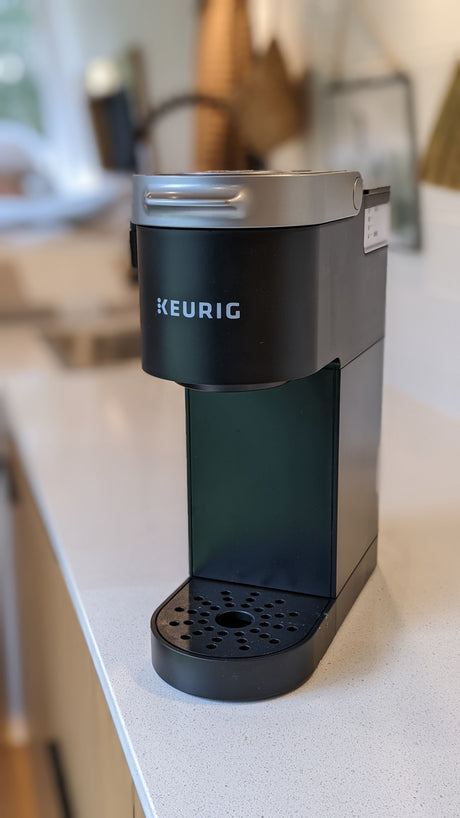 A black Keurig coffee maker, a convenient amenity often found in RV rentals for easy hot drinks.