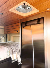 RV rental bedroom area: wood-paneled ceiling, vent fan, recessed lights, and comfy bed. Stainless fridge and cabinets too.