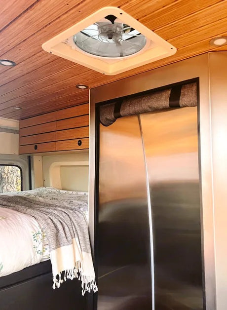 RV rental bedroom area: wood-paneled ceiling, vent fan, recessed lights, and comfy bed. Stainless fridge and cabinets too.