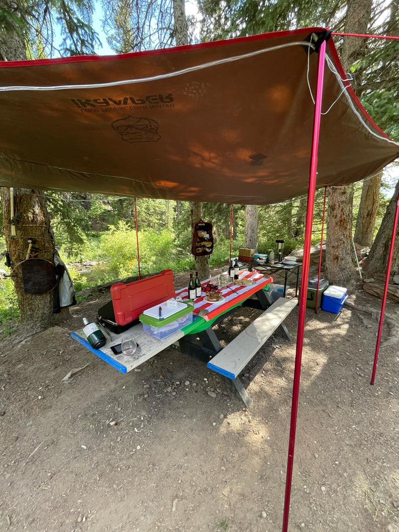 Cozy RV rental camp setup: Enjoying an outdoor picnic & cookout under a spacious awning by the stream. — photo 13