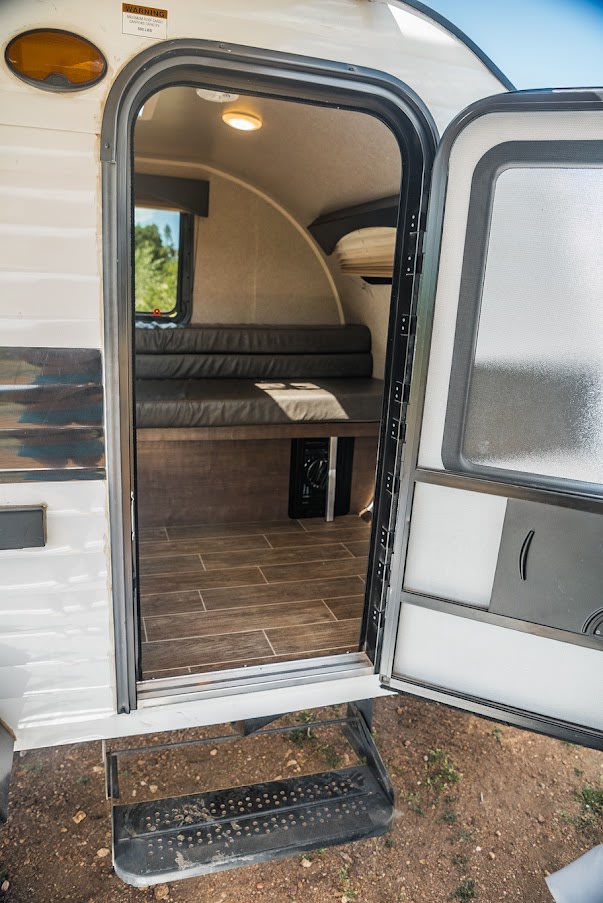  and towels.|Experience camping freedom! This white truck and RV rental teardrop camper offer a cozy outdoor setup with awning — photo 9