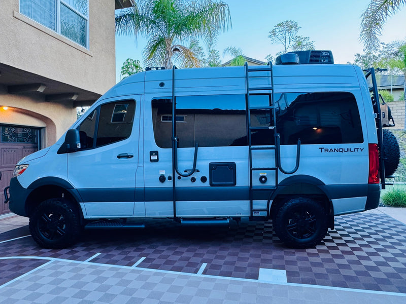  is parked on a checkered driveway.|This **RV rental** Sprinter van — photo 9
