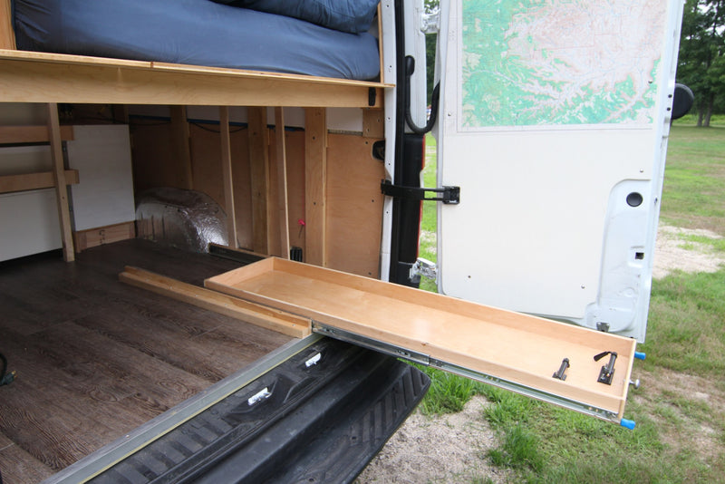 RV rental: Camper van conversion with extended pull-out storage tray, elevated bed, and wood flooring. Spacious interior. — photo 14