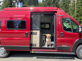 A happy yellow lab sits in a red Winnebago rv rental. This cozy camper van is ready for its next adventure!