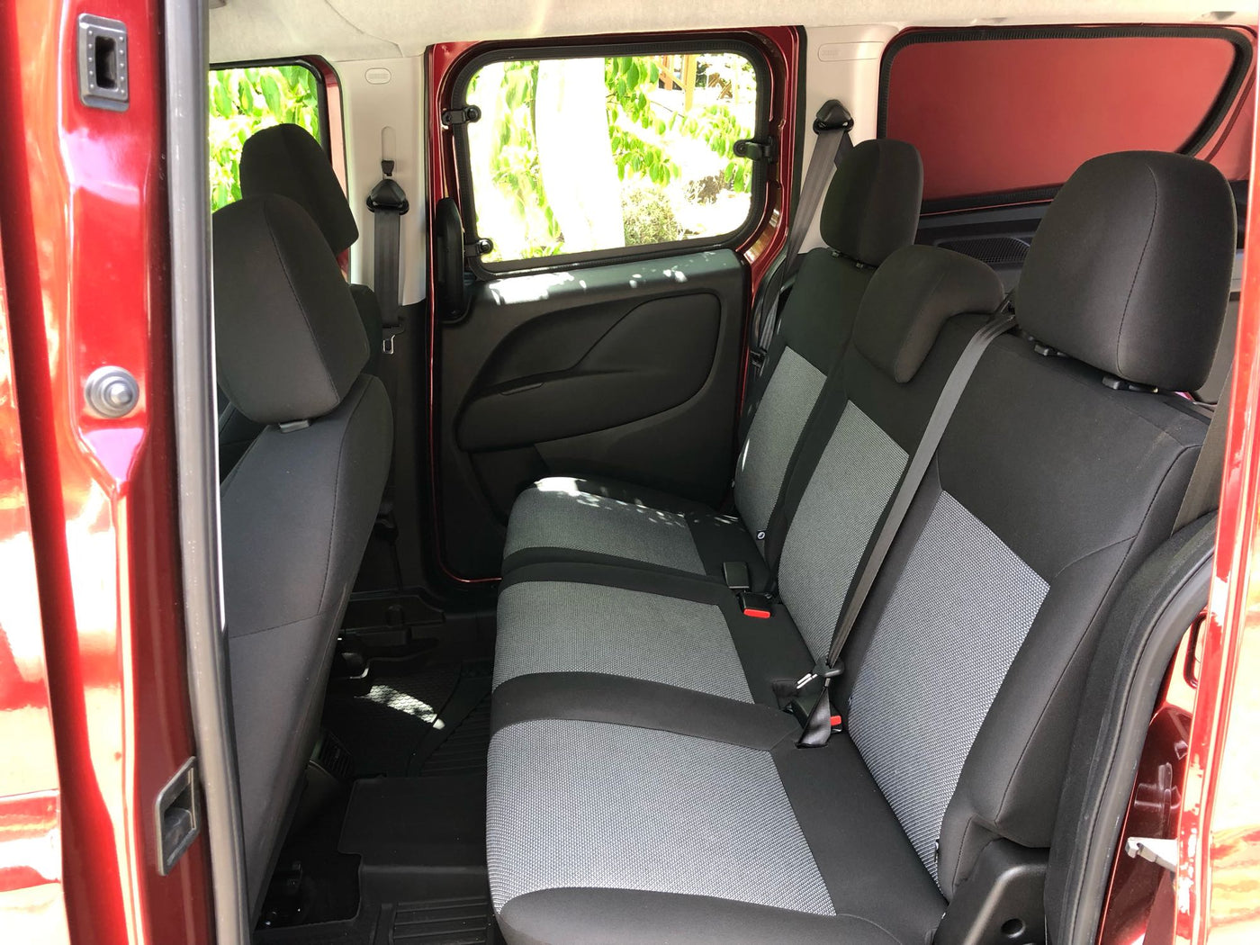 Inside an RV rental: comfortable rear seats and convenient sliding side doors for easy access. — photo 11