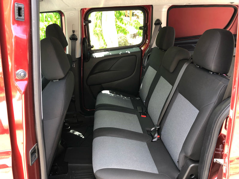 Inside an RV rental: comfortable rear seats and convenient sliding side doors for easy access. — photo 11