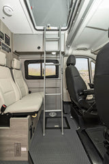 Inside an **rv rental**: a ladder leads to an overhead bunk, with bench seating & storage on the left, and the driver's area on the right.