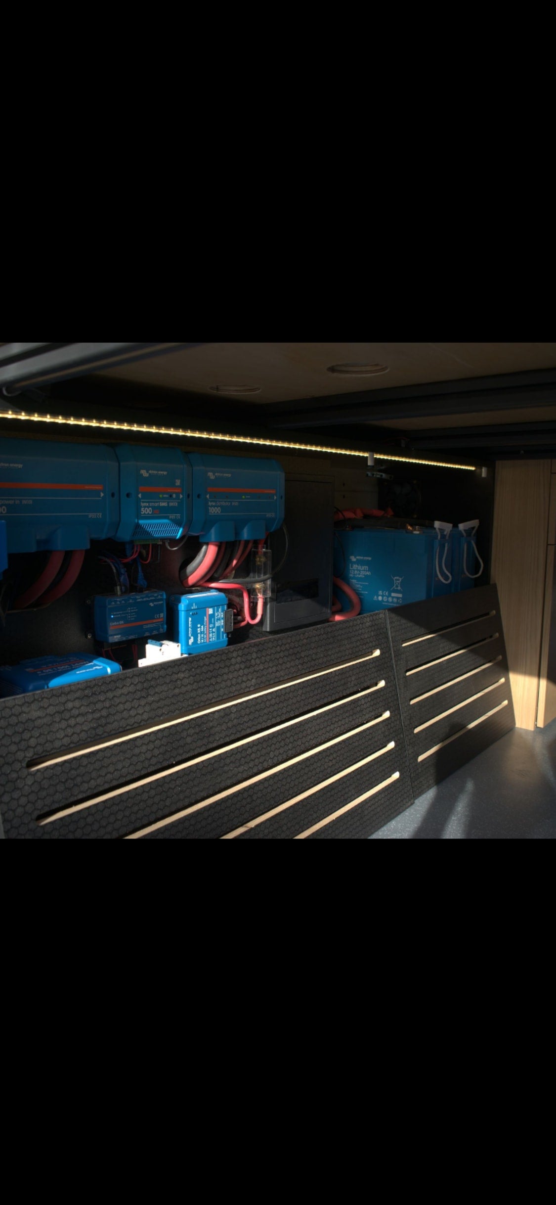 RV rental's organized electrical system: Victron Smart BMS, distributor, and lithium batteries for reliable power.