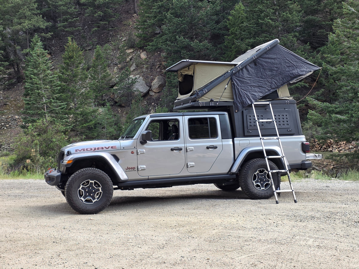 This silver Jeep Gladiator, equipped with a rooftop tent and ladder, makes for an ideal RV rental for off-road overlanding. — photo 6