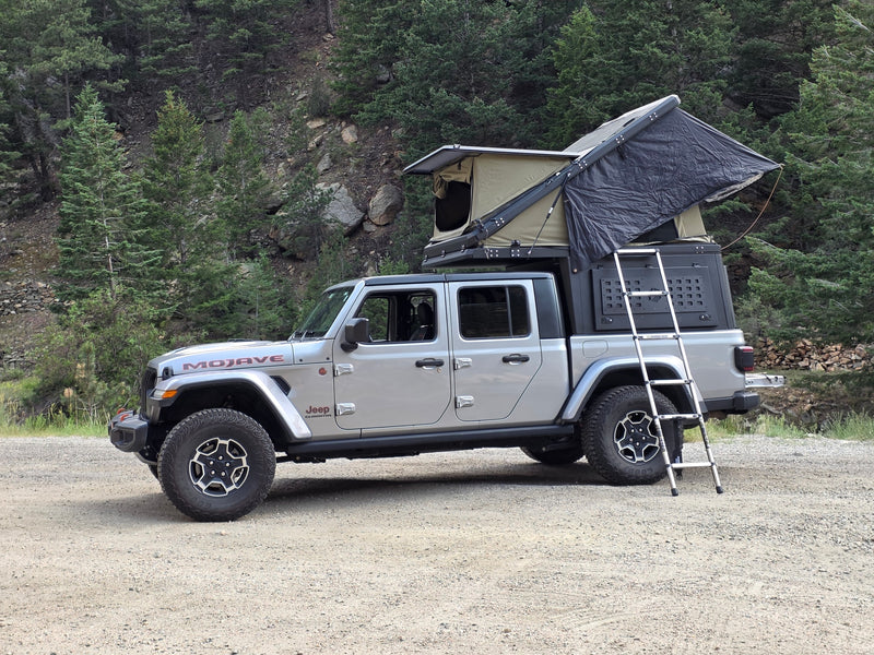This silver Jeep Gladiator, equipped with a rooftop tent and ladder, makes for an ideal RV rental for off-road overlanding. — photo 6